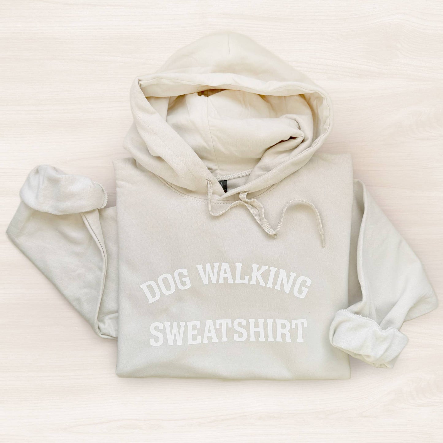 Light gray hoodie with 'DOG WALKING SWEATSHIRT' text on a light beige background