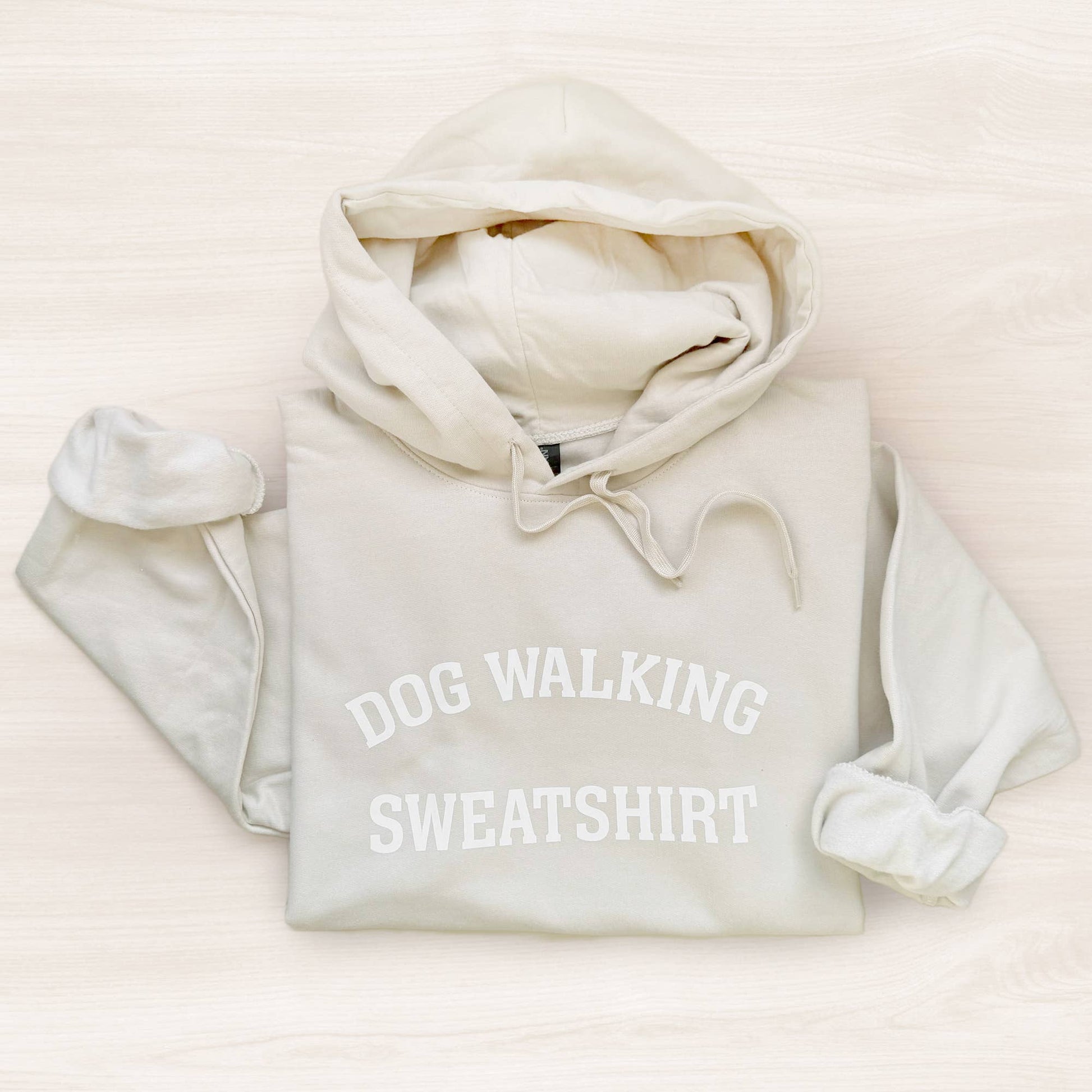 Light gray hoodie with 'DOG WALKING SWEATSHIRT' text on a light beige background